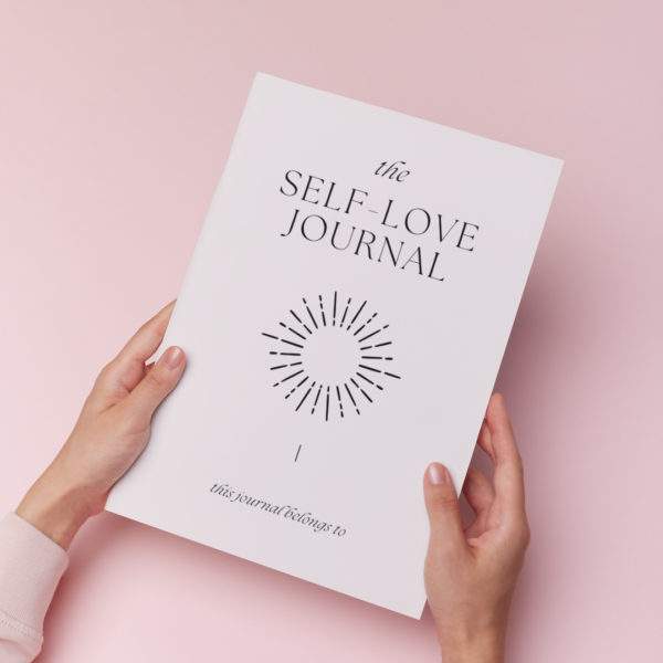 hand handling a printed self-love journal