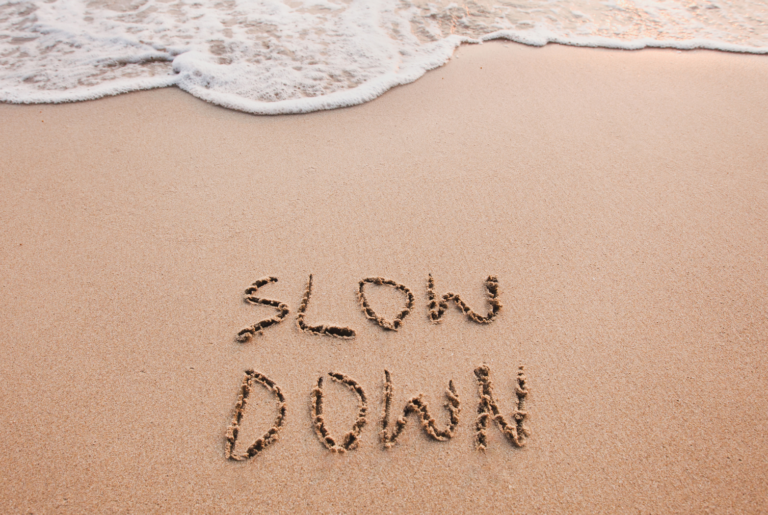 picture that says Slow Down which is an important virtue in mindfulness and meditation